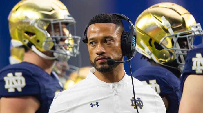Notre Dame coach with severel players in background at 2022 Fiesta Bowl
